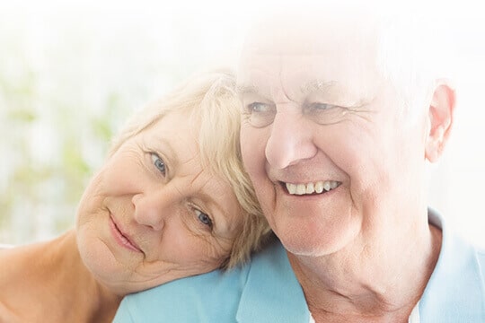 Senior woman is resting her head on husband's shoulder