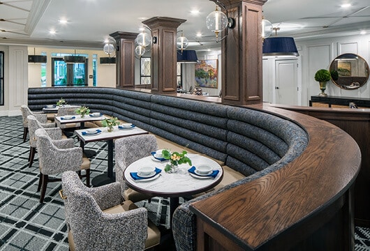 Longleaf main dining room with curved booth seating as well as tables and chairs and wooden columns and trim
