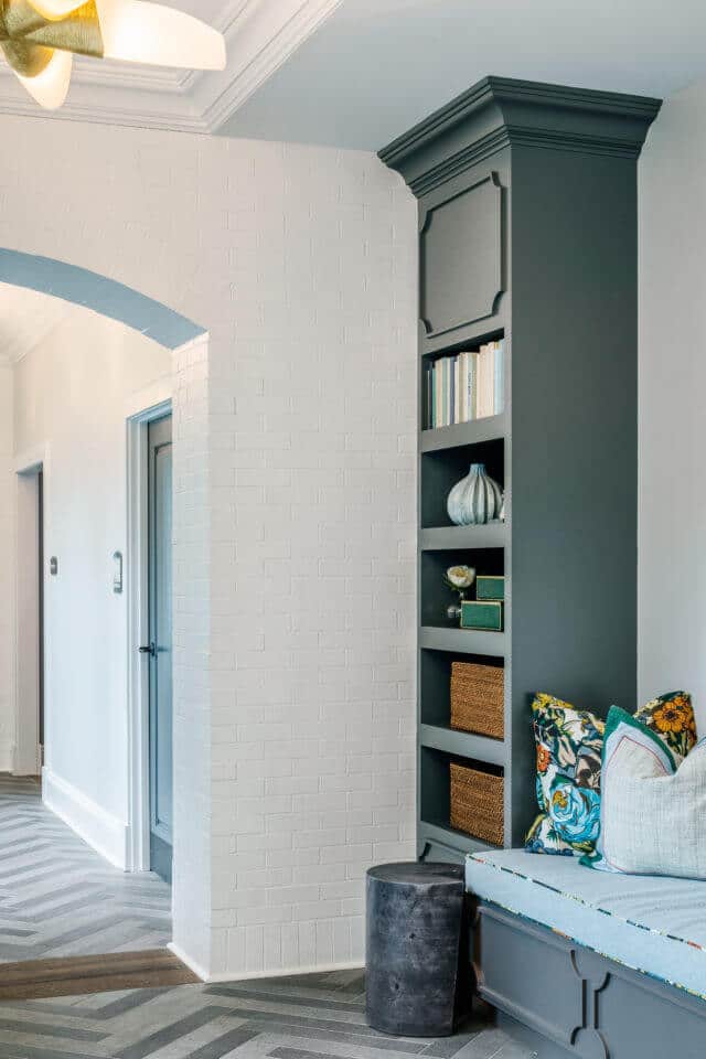 Longleaf common space with gray shelves, bench seating, white walls and grey chevron pattern on flooring