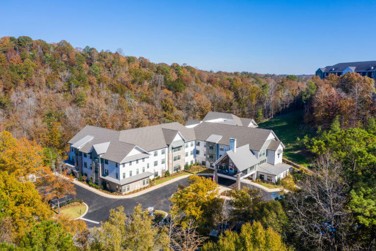 Aerial view of Longleaf community looking at front entrance with fall trees surrounding community