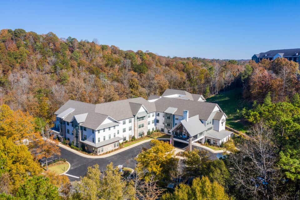 Aerial view of Longleaf community looking at front entrance with fall trees surrounding community