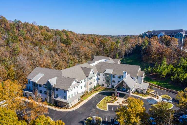 Aerial view of Longleaf community looking at front entrance with fall trees surrounding community