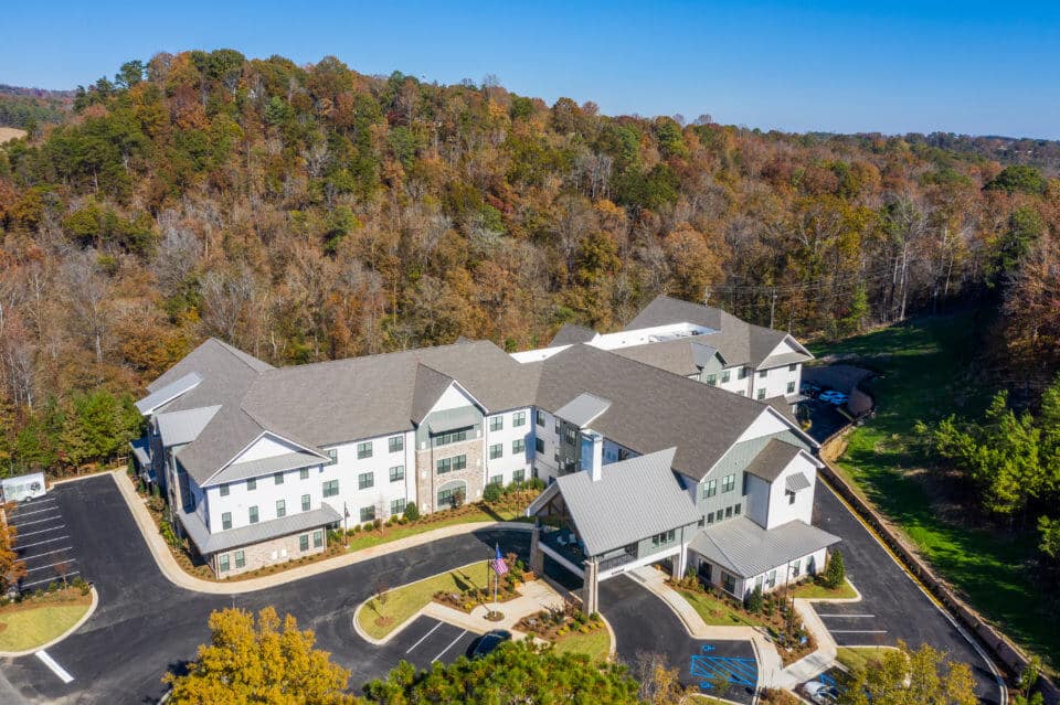 Aerial view of Longleaf community looking at front entrance with fall trees surrounding community