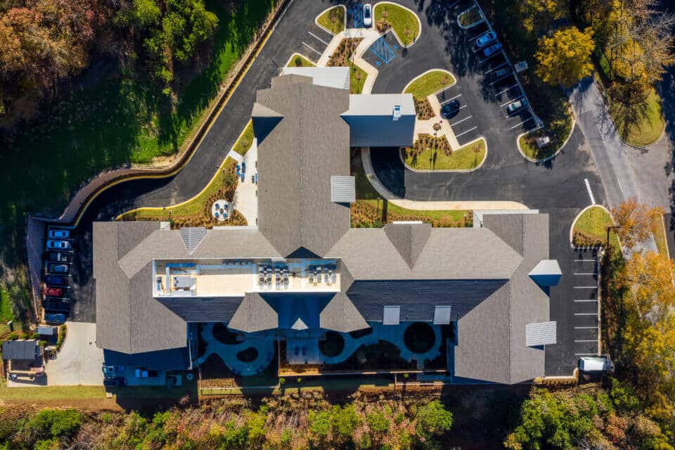 Aerial view of Longleaf comunity looking straight down at roofline with back of community to left and front to the right