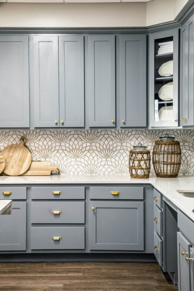 Blue cabinets and white countertops with basket and wooden decor in Longleaf common space