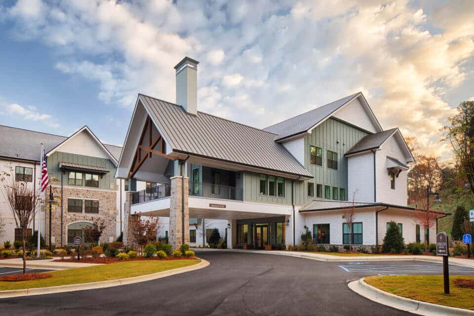 Exterior side front view of Longleaf Liberty Park entrance circle driveway with blue skies and white clouds