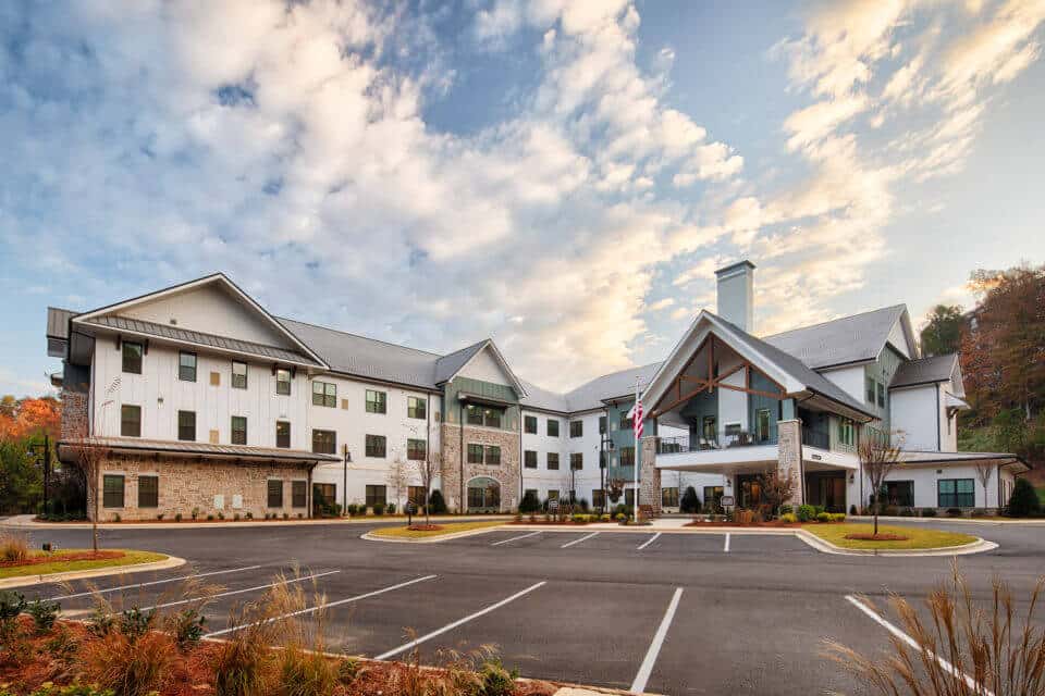 Exterior front view of Longleaf Liberty Park entrance with blue skies and white clouds