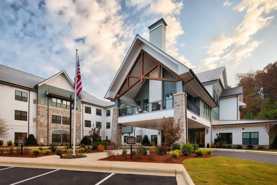 Exterior front view of Longleaf Liberty Park entrance circle driveway with blue skies and white clouds