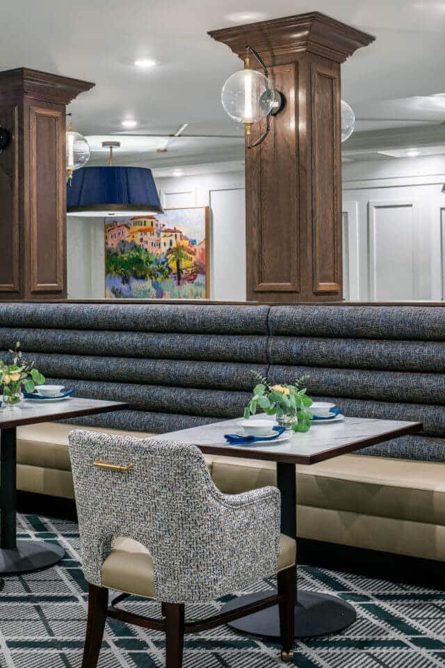 Longleaf main dining room blue and beige booth, tables and chair with wood columns and globe light fixtures above