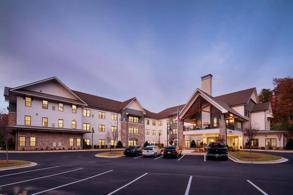 Exterior view of Longleaf Liberty Park at dusk with lights on and dark blue skies