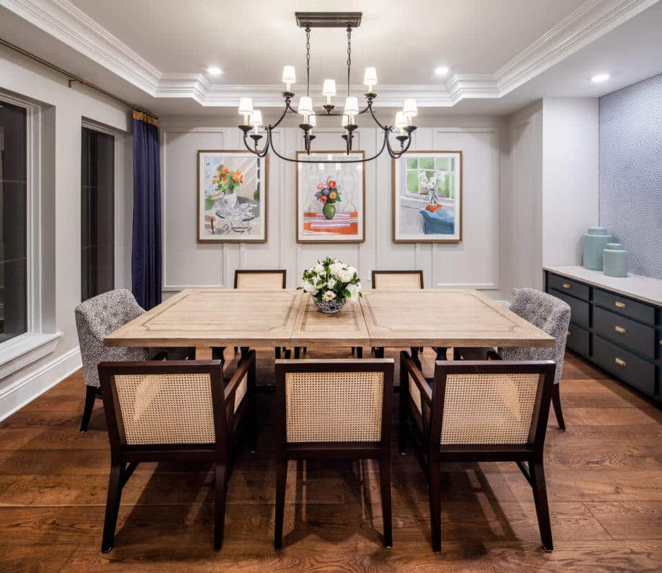 Longleaf private dining room with formal table and chairs with framed art on walls and chandelier above