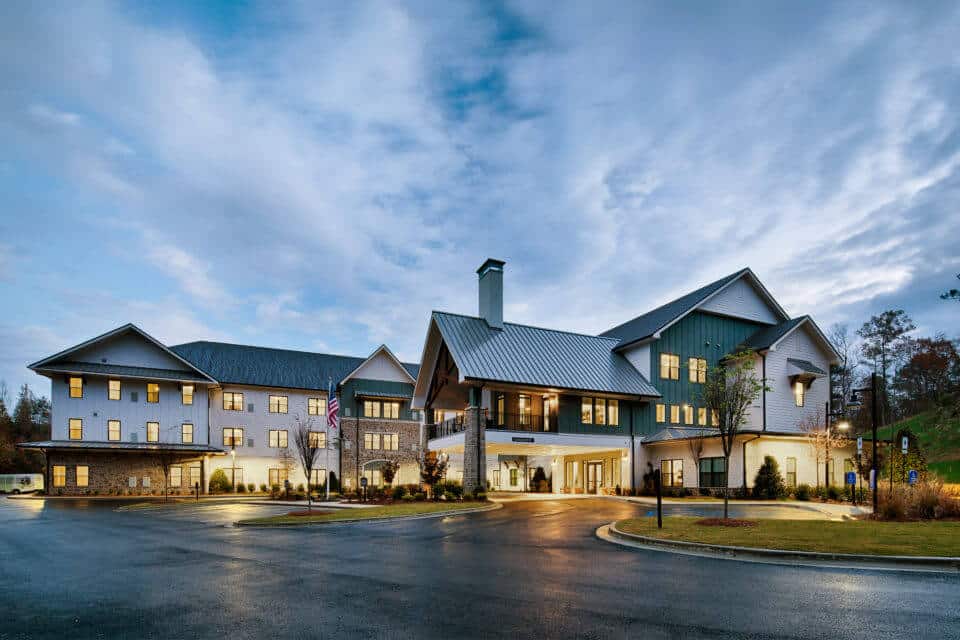 Exterior view of Longleaf Liberty Park at dusk with lights on and cloudy skies