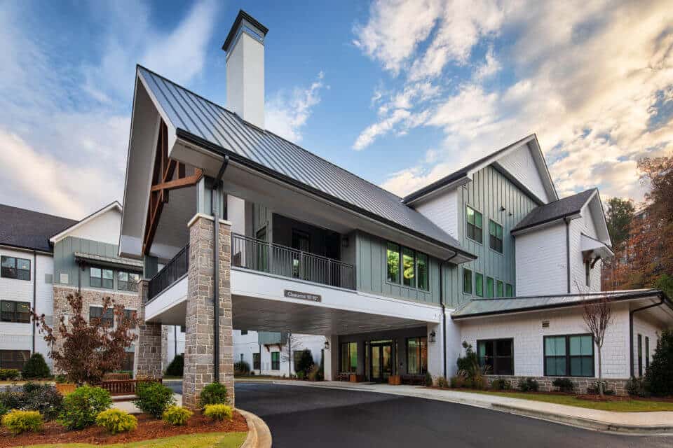 Exterior view of Longleaf Liberty Park entrance circle driveway at daytime with blue skies and white clouds